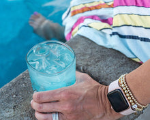 Load image into Gallery viewer, Scotsman Brilliance cuber luxury outdoor ice machine showing the cubes in a drink by the pool