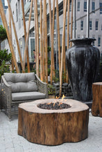 Load image into Gallery viewer, Elementi rustic manchester tree stump fire pit in a patio setting