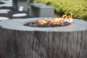 Elementi rustic manchester tree stump fire pit in a patio setting