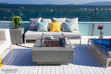 Load image into Gallery viewer, Elementi Manhattan fire pit table on a deck overlooking the ocean