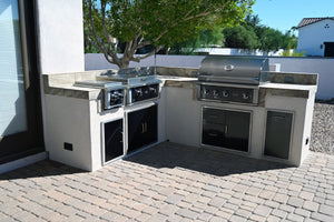 Wildfire black stainless steel grill, griddle and burner built in an outdoor kitchen