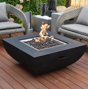 Modeno by Elementi Aurora fire pit table shown with a flame on a  patio deck