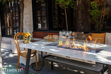 Load image into Gallery viewer, Elementi Plus Oslo dining table in an outside setting with flame