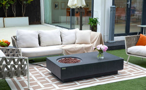 Elementi metropolis fire table in darg gray. Shown on a patio