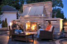 Load image into Gallery viewer, Napoleon Riverside clean face fireplace shown on a beautiful patio