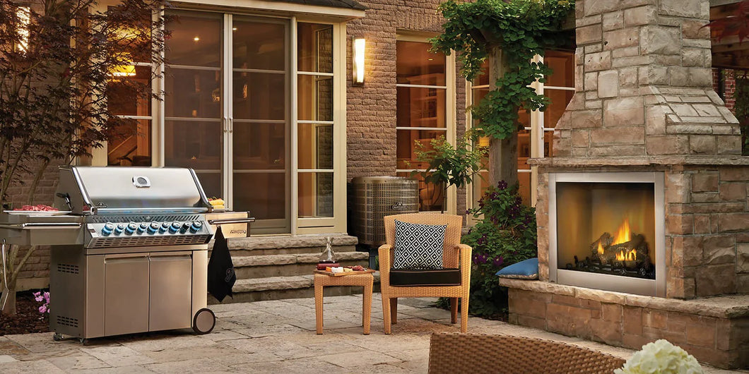 Napoleon Riverside fireplace shown on a cozy patio with a brick/stone surround