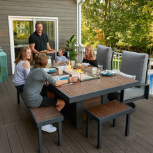 Load image into Gallery viewer, The outdoor greatroom company kenwood dining height fire table shown with people sitting around it on a patio/deck