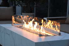 Load image into Gallery viewer, elementi plus carrara fire table with flame and wind guard on a patio