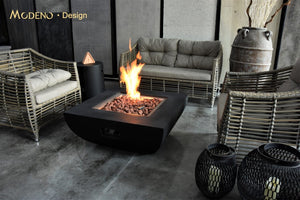 Modeno by Elementi Aurora fire pit table shown with a flame on  a patio