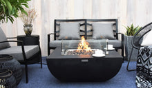 Load image into Gallery viewer, Modeno by Elementi Aurora fire pit table shown with a flame on a  patio