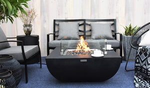Modeno by Elementi Aurora fire pit table shown with a flame on a  patio