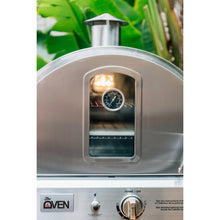 Load image into Gallery viewer, Summerset outdoor pizza oven built in or countertop version. shown on a patio with the light on