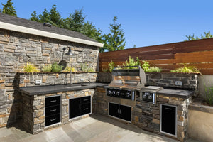 Wildfire 36 black stainless steel grill and side burner in an outdoor kitchen with matching drawers and doors